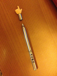 a pen with a pointing-hand-shaped cap